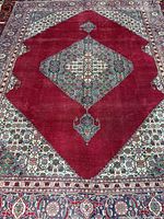 Full view showing entire rug, crimson field, medallion, border