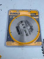 Front view of DeWalt 12" 80T blade in clamshell package