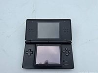 Console open showing dual screens, buttons and controls