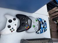 Front view of four Xbox controllers in assorted colours