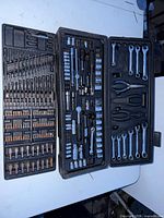 Entire opened three-panel tool case showing all contents