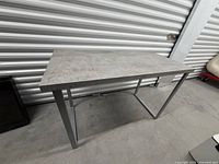 Overall view of rectangular table showing top and frame