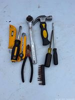 Group of assorted hand tools laid flat