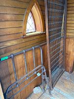 Headboard, footboard and spring support leaning against wood wall