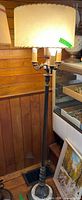Full view of bronze and marble floor lamp with shade