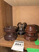 Front view of all three ceramic insulators on shelf