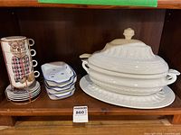Full lot showing mugs on stand, rectangular dishes, Eldreth tureen with lid, ladle and underplate