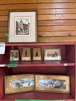 Shelf view showing all seven framed artworks
