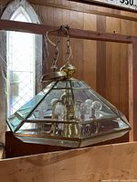 Full view of geometric glass and brass chandelier