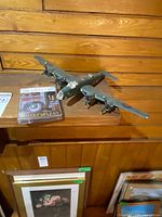 Overall view of bomber model alongside cassette on wooden shelf
