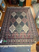 Full view of rug showing overall design, colors, and fringe