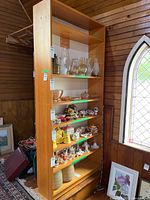 Front view of tall wooden bookshelf with shelves