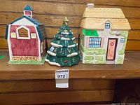 Front view of all three ceramic containers: barn, tree, cottage