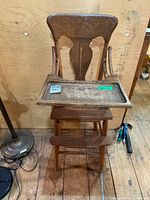 Full view of oak high chair with tray attached
