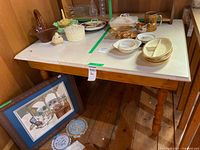Full view of rectangular wood table with turned legs, items on top not included