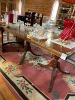 Full view of wooden dining table on rug