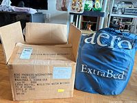Aero Products International shipping box next to blue drawstring storage bag