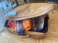 Suitcase partially open with visible clothing