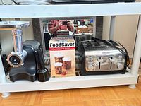 Overall shot showing meat grinder, FoodSaver box, and toaster on shelving