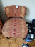 Front view of geometric upholstered slipper chair showing full seat, backrest and legs