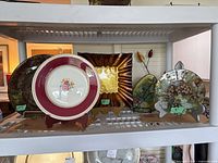 Shelf view showing multiple crackle glass plates of varying sizes
