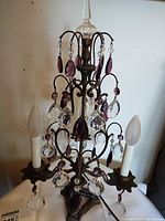 Full view of lamp unlit showing metal frame, crystal drops, two sockets