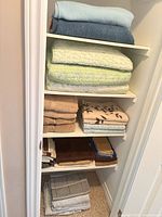 Full closet view showing all linens stacked on shelves