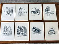 Eight of the sketch prints laid out on table