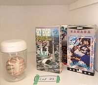 overall lot showing baseball in case and two VHS tapes