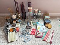 Full layout of candles, holders and accessories on carpet