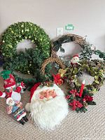 Group shot of all wreaths, Santa face, snowman