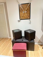 Overall view of ottomans, storage chest and golf wall hanging