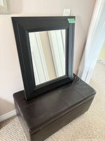 Mirror resting on storage ottoman bench showing overall appearance