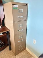 front view of beige four-drawer metal filing cabinet