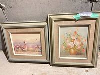 Both framed prints side by side against wall