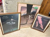 Three framed ballet posters leaning against wall