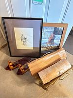 Group showing both framed prints, log holder and candle holders