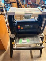 Front view of Mastercraft planer on stand with tables folded down