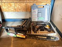 Chainsaw and sander case on workbench