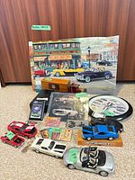 Group shot of all items including diecast cars, clock, puzzle, wooden car, boxed cars and booklets