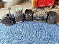 Overall view showing two JVC speakers, Sony main unit and two Sony speakers