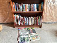 Two-shelf bookcase filled with assorted novels and children’s books