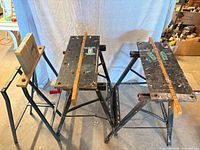 Three of the folding workbenches showing wood tops and metal frames