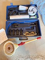 open carrying case showing all pressure washer accessories and goggles