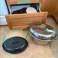 Overall view of stainless steel oval roasterc enamel roaster lid and open drawer with bakeware