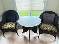 Full set showing table and two chairs with cushions and pillows