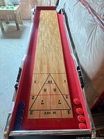 Full length view of shuffleboard table with pucks in scoring areas