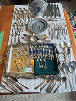 Full layout of tray, flatware, cake basket, pewter plate and collector spoons