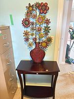 Overview of console table with metal floral sculpture displayed on top