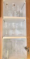 Cabinet shelves showing all crystal stemware sizes